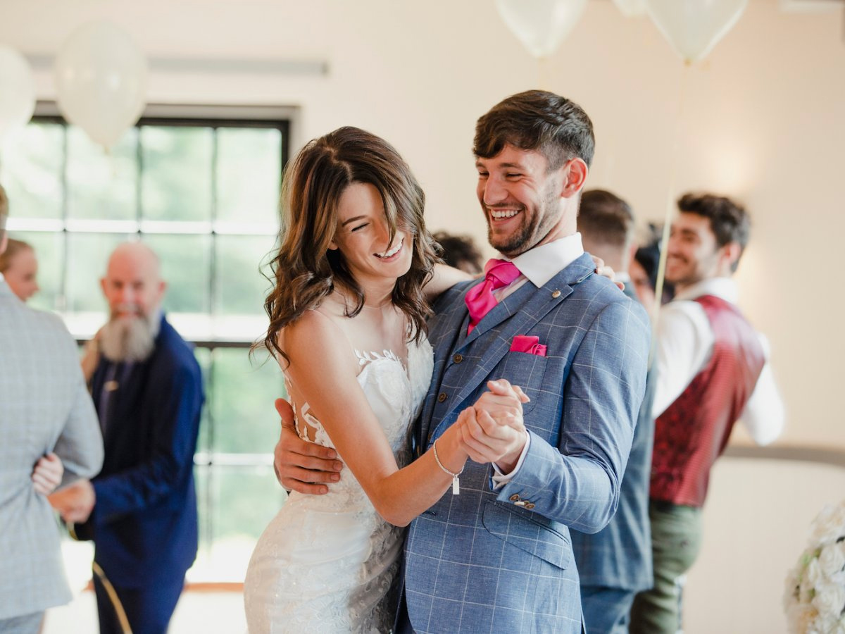 Couple dancing and smiling at their wedding reception